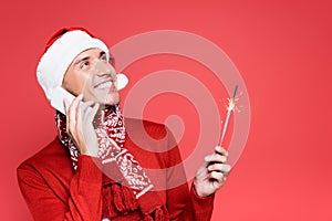 Man in santa hat holding sparker