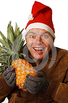 Man in Santa hat with pineapple.