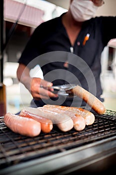 Man and sausages look very simple cooking