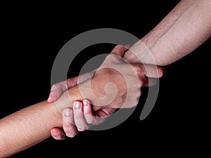 Man saving, rescuing and helping woman by holding or griping the forearm. photo