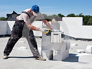 Man sawing concrete block