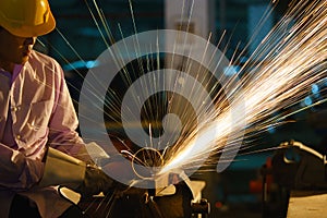 Man sawing metal by grinder