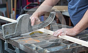 Man Sawing a Piece of Wood for a DIY Project