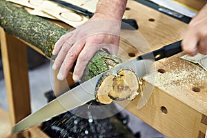 Man sawing wood handsaw