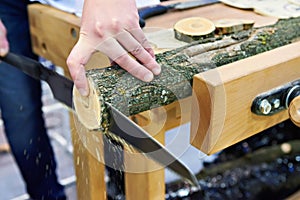 Man sawing wood handsaw on carpentry table