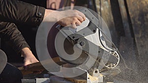 Man saws boards with a circular saw