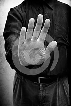 A man saying stop or no with the open hand gesture