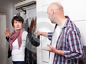 Man says goodbye to his wife and takes keys in the hallway