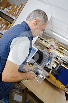 Man scanning producto with handheld device photo
