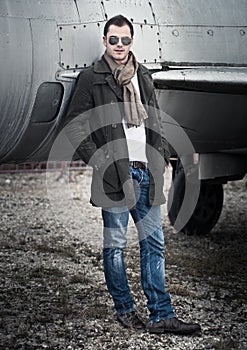 Man with Scarf standing by a Plane