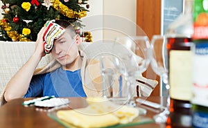 Man in scarf stuping towel to head