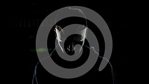 Man in scary mask isolated on dark background, serial killer hiding identity