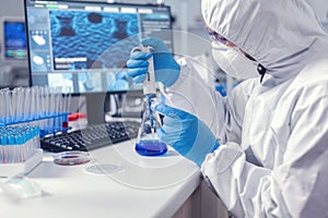 Man in scientific lab working with micropipette and petri dish
