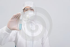 Man scientist wearing biological protective uniform suit clothing, mask, gloves with hand sanitizer dispenser for sanitizing virus