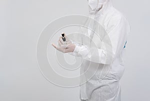 Man scientist wearing biological protective uniform suit clothing, mask, gloves with hand sanitizer dispenser for sanitizing virus