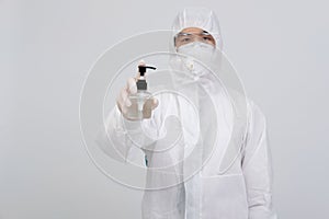 Man scientist wearing biological protective uniform suit clothing, mask, gloves with hand sanitizer dispenser for sanitizing virus