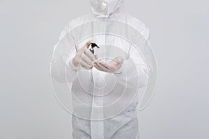 Man scientist wearing biological protective uniform suit clothing, mask, gloves with hand sanitizer dispenser for sanitizing virus