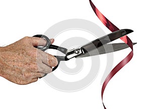 Man with scissors cuts red tape over white