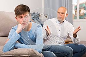 Man scolding son at home