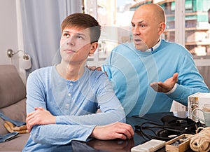 Man scolding son at home