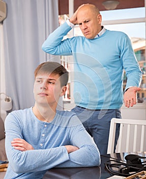 Man scolding son at home