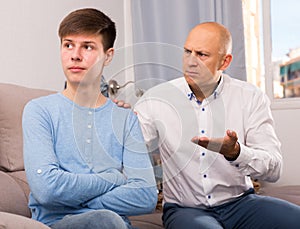 Man scolding son at home