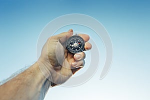 Man Scout Explorer Searching Direction With Compass On Blue Sky