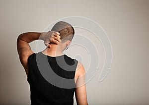 Man scratching back of head