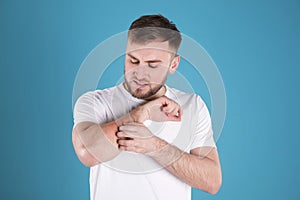 Man scratching forearm. Allergy symptoms
