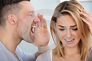 Man Screaming In His Wife`s Ear