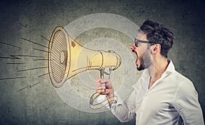 Man screaming into loud speaker photo