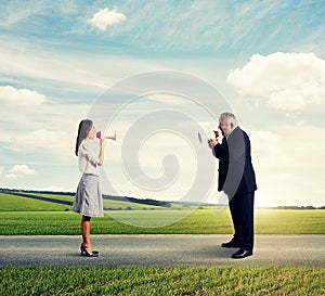 Man screaming at mad woman at outdoor