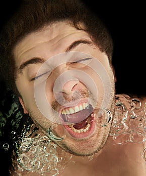 Man screaming underwater with bubbles