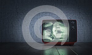Man screams inside an old TV set on the floor