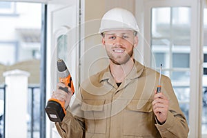 man screwing with drill at home