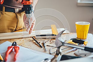 Man Screwing A Into Wood