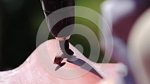 Man screws a screw into the roof. Stock footage. The professional worker works on installation of a roof of a roof by