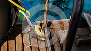 a man with scuba diving is sitting on board a yacht, preparing to dive,