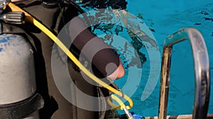 a man with scuba diving is sitting on board a yacht, preparing to dive, diving in the sea