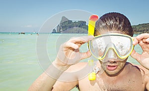 Man with scuba mask in clear sea