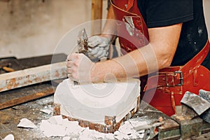 Man sculptor creates sculpt bust gypsum human woman sculpture. Statue craft creation workshop