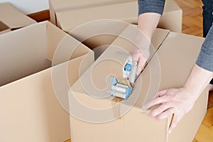 Man sealing a shipping cardboard box