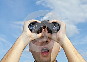 Man searching with binoculars.