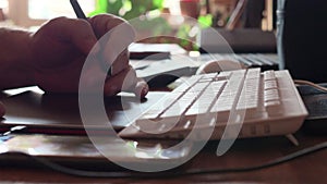 Man searching information with pc touch pad. Male fingers is typing on touchpad of black laptop with english keyboard