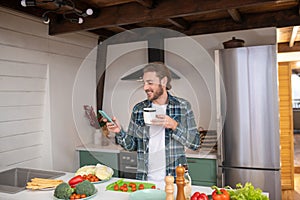 Man searchingg a recipy on internet while cooking alone