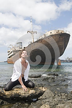 Man in the seaside with abandoned ship