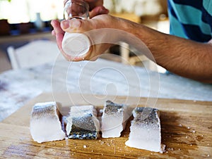 Man seasoning zander fillets