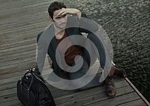 Man seated on wooden planking photo