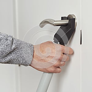 Man secures a door with a blocker bar