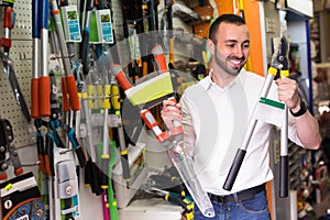 Man selecting household tools in store